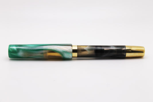 Ferryman Piston Filler in Green, Black, Silver, and Brass
