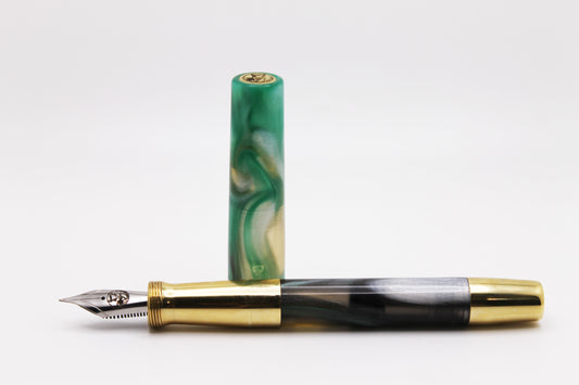 Ferryman Piston Filler in Green, Black, Silver, and Brass